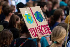 climate demonstration with protester holding a sign