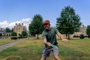 Undergraduate student, Calvin Teague, demonstrates an optimal thumb grip on a mid-range disc.