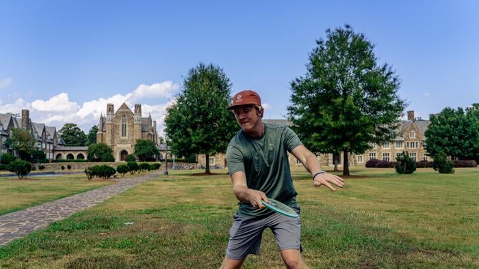 Undergraduate student, Calvin Teague, demonstrates an optimal thumb grip on a mid-range disc.