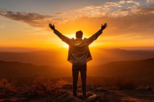 Man raising arms high in success