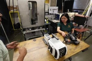 Mechanical engineering professor Lulin Jiang, Ph.D., and her research team on the novel Swirl Burst injector inside the Cornerstone Atomization and Combustion Lab at Baylor University. (Robert Rogers/Baylor University)