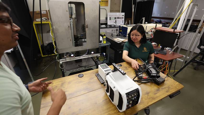 Mechanical engineering professor Lulin Jiang, Ph.D., and her research team on the novel Swirl Burst injector inside the Cornerstone Atomization and Combustion Lab at Baylor University. (Robert Rogers/Baylor University)