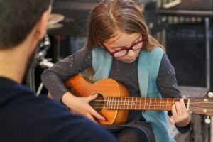 Girl playing a small guitar