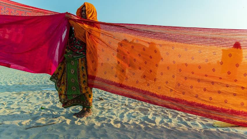 woman in saree washing another saree