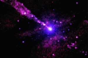 Using the deepest X-ray image ever made with Chandra of Centaurus A, astronomers have found an unusual mark from the giant black hole’s powerful jet striking an unidentified object in its path. A patch of V-shaped emission connected to a bright source of X-rays is located close to the path of the jet from the supermassive black hole (highlighted in the inset). The arms of the “V” are at least about 700 light-years long. In this image, low, medium, and high-energy X-rays from Chandra are colored pink, purple, and blue respectively.