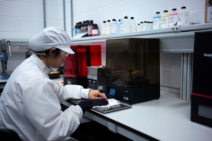 Logan Zhang, a PhD student at Swansea University's Faculty of Science and Engineering, printing materials in a lab.