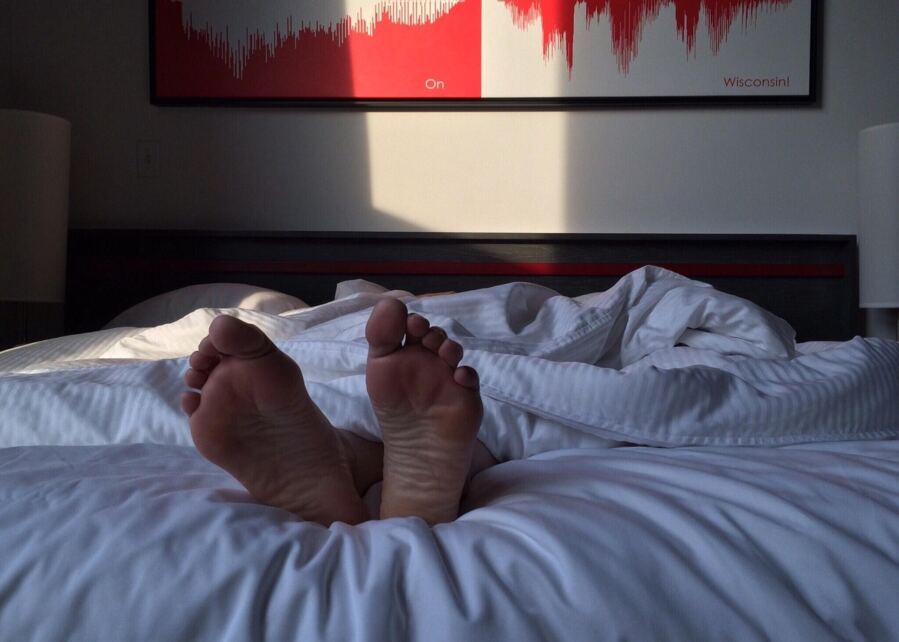 feet sticking out of bed covers