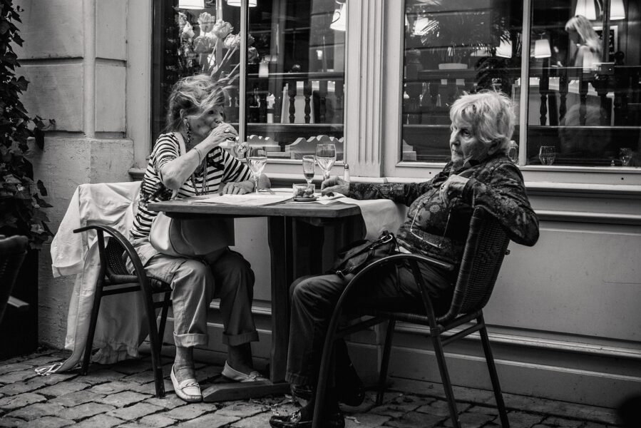 black and white photo of two women at an outdoor restaurant