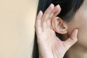 woman cupping her ear