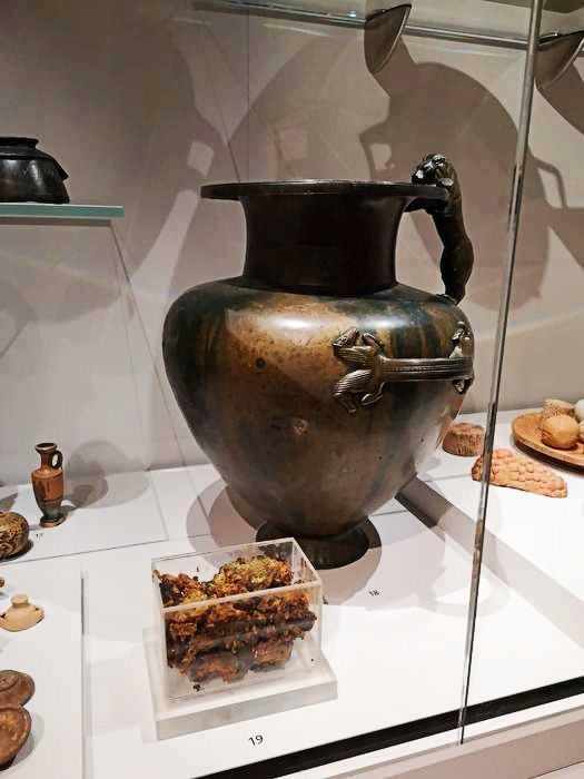 This bronze jar on display at the Ashmolean Museum contained a mysterious substance (shown in the foreground) that is very likely ancient honey.
