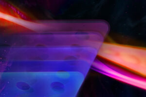 Graphic illustrating MIT’s new platform for manipulating light on the nanoscale. Thin structures represent patterned chromium sulfide bromide, a layered quantum material with different optical responses (represented by different shades of blue) depending on the application of a magnetic field. The orange and pink structure represents the resulting enhancement of light-matter interactions.