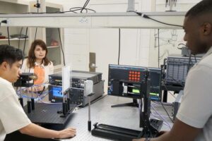 From left, researchers Haoze Chen, Yasaman Ghasempour, and Atsutse Kludze developed a system that can bend ultrahigh-frequency transmissions to navigate complex, dynamic environments.