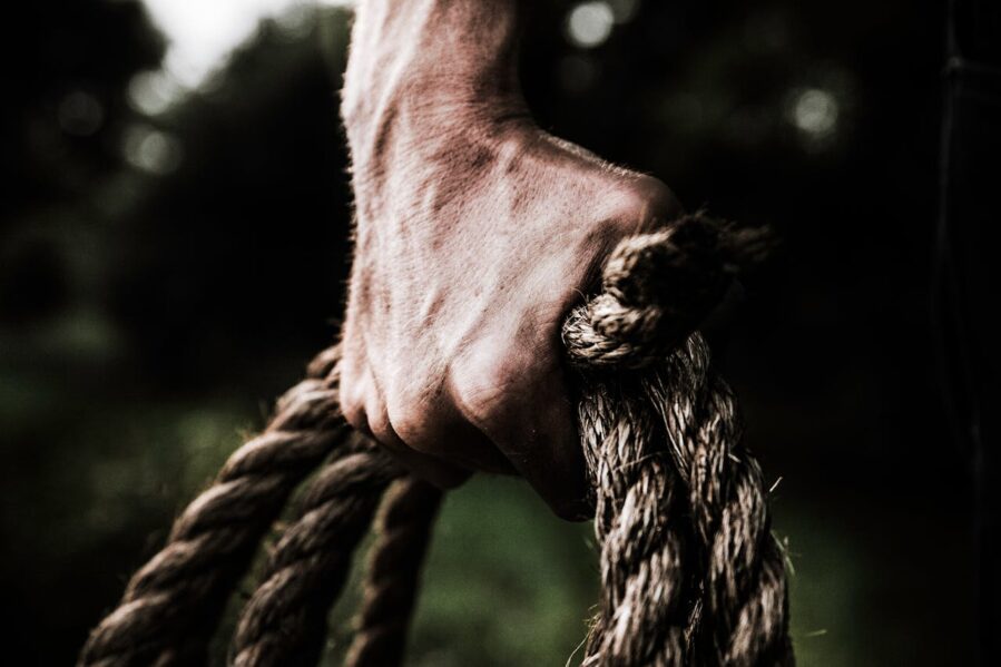 male hand gripping rope