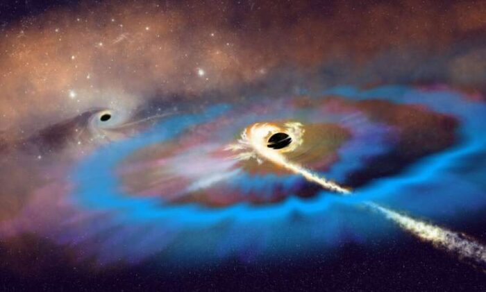 Artist’s interpretation of two massive black holes (MBHs) within a galaxy. A tidal disruption event unfolds around the MBH that resides away from the galactic center and matter from a disrupted star swirls into a bright accretion disk, launching an energetic outflow and resulting in two bright radio flares. Credit: NSF/AUI/NSF NRAO/P.Vosteen