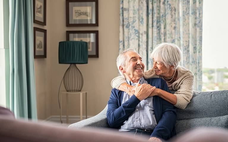 older couple hugging at home