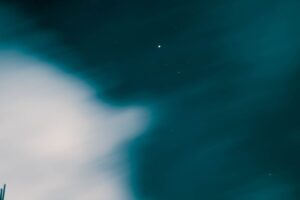 a distant planet appearing as a speck of light in the night sky
