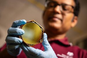 Dr. Rupak Mahapatra, an experimental particle physicist, holds a TESSERACT detector. The highly sensitive devices, which are fabricated at Texas A&M University, are deepening the search for dark matter and have potential applications in quantum computing.