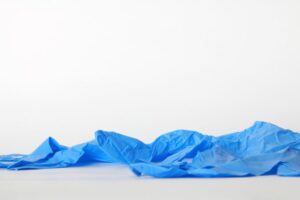 used rubber gloves on the ground as trash