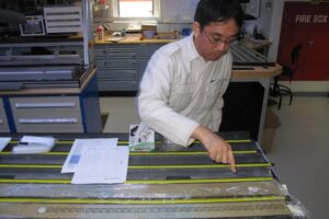 Yuhji Yamamoto examines drilling cores on the JOIDES Resolution during the 2012 expedition in the North Atlantic.