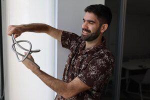 Evangelos Piliouras, a graduate student in physics, demonstrates a space curve.