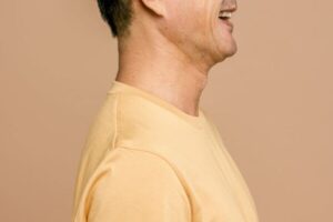 side view of a man wearing a wide smile. Photo by Ketut Subiyanto on Pexels.com