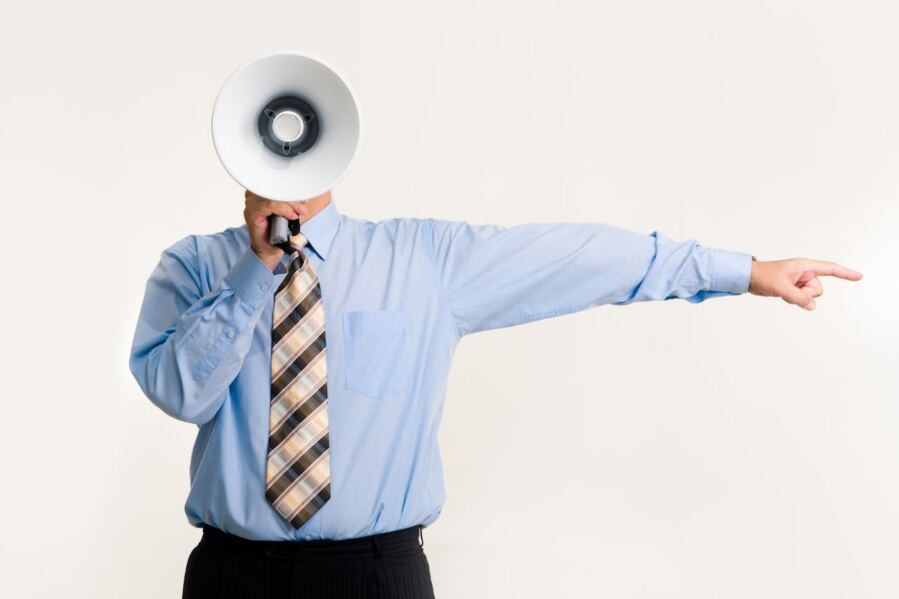 Man speaking through a megaphone that covers his face