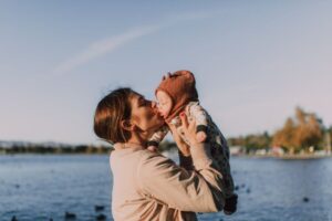 mother and baby at a lake