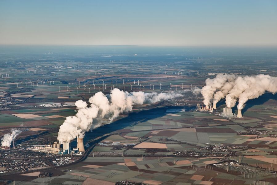 Lignite coal fired power plants in Germany, surrounded by windmills.