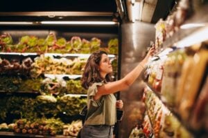 woman selecting item at supermarket