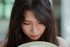 Asian woman's downward facing face