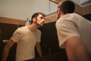 man looking in mirror