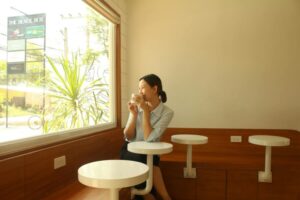 a woman sitting while looking outside a window
