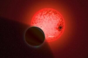 An artist’s conception of the gas giant planet TOI-5205 b orbiting a small, cool red dwarf star.
