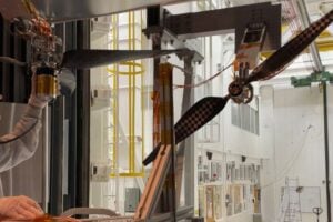 Engineer Jaakko Karras inspects a next-generation Mars helicopter rotor blade prior to testing it at supersonic speeds in the 25-Foot Space Simulator at NASA’s Jet Propulsion Laboratory in November 2025.