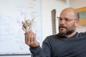 Andrew Kern, an academic expert in population genetics and machine learning, develops new tools for studying evolutionary biology. (Photo by Charlie Litchfield)