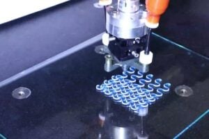 A lattice of active and passive filaments being printed via rotational multimaterial 3D printing.