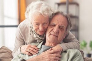 eldery man and woman hugging