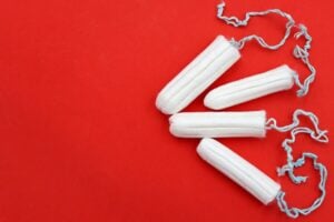 clean, unused tampons on a red background