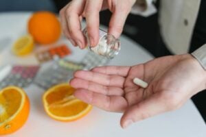 hand holding a vitamin C capsule