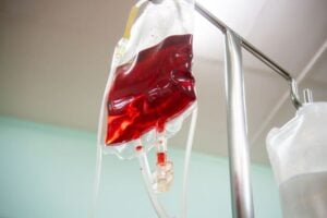 blood bag hanging from an IV rack