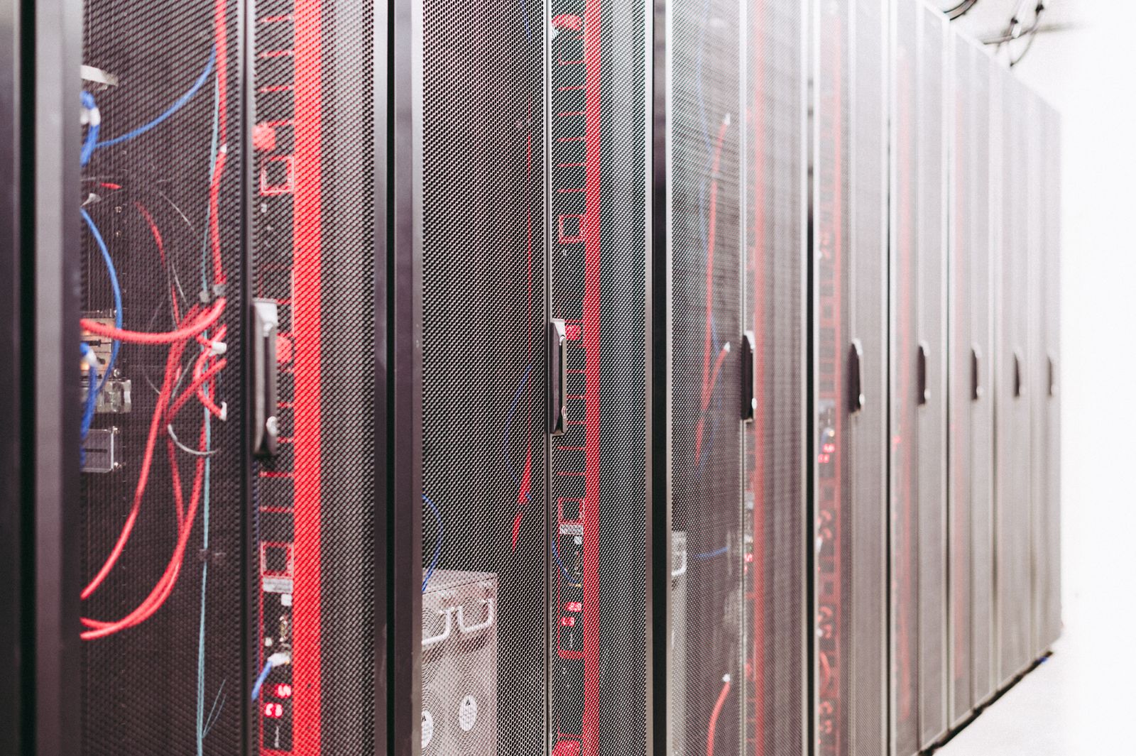 Rows of illuminated server racks inside a modern data center