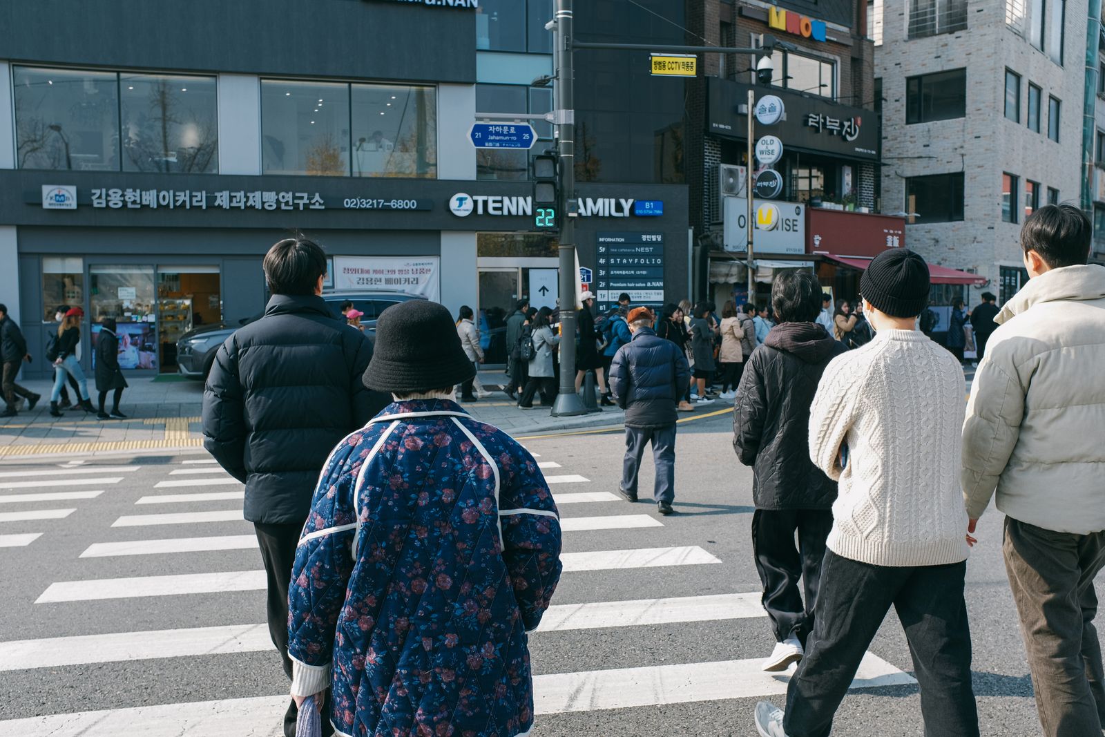 Pedestrians crossing a broad street among modern buildings in Seoul, South Korea