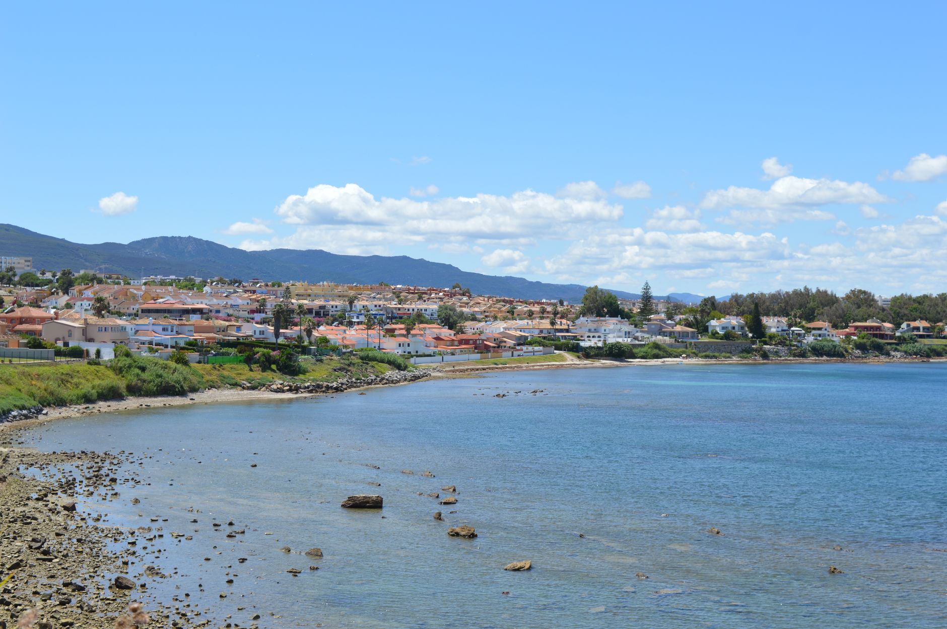 Scenic coastal view of Gibraltar with clear blue sky, mountains, and tranquil sea.