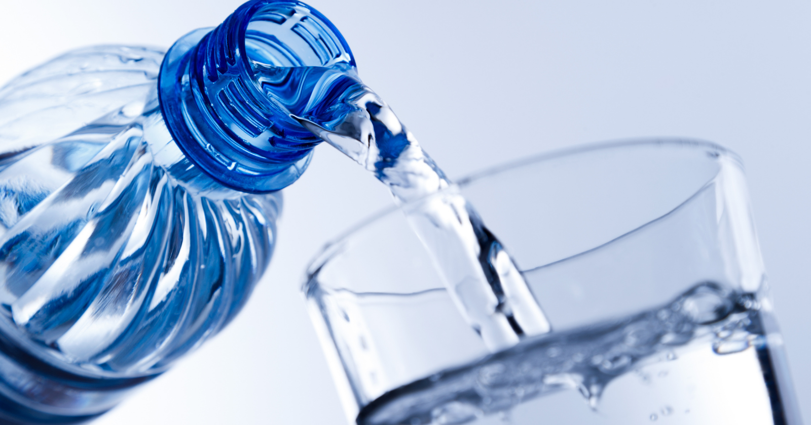 Water being poured from a bottle into a glass