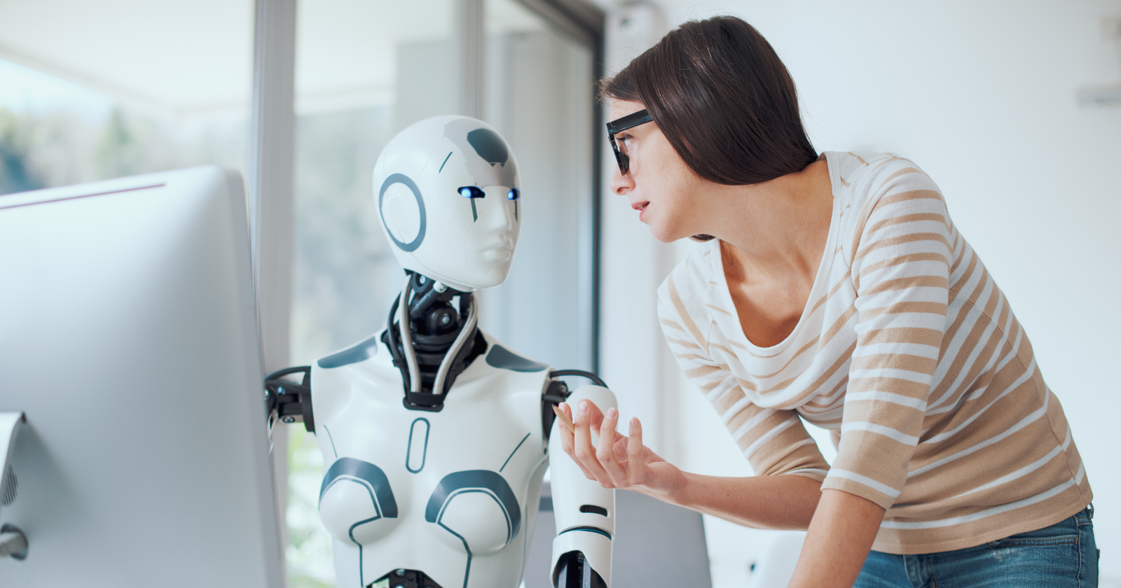 Woman interacting with a humanoid robot