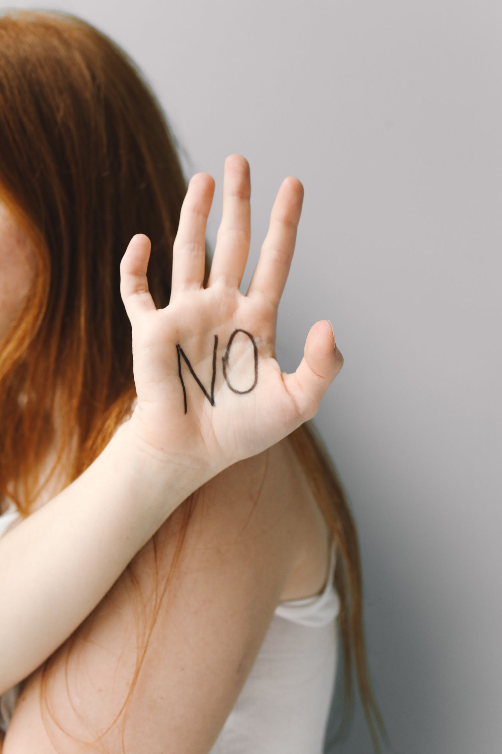 A hand with the word NO written on the palm against a bright background, a representative image and not a photograph of any person discussed in the article.