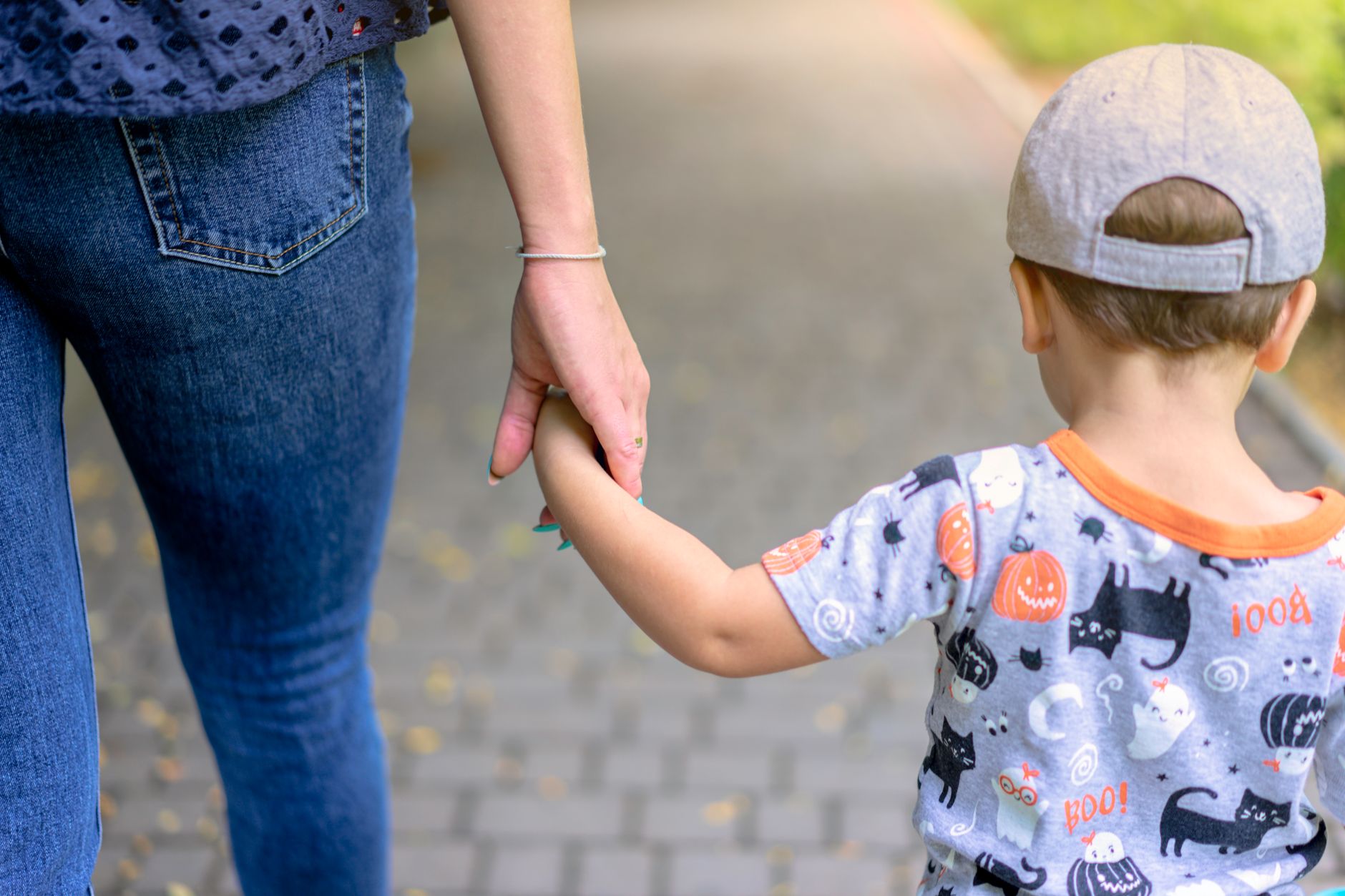 Adult holding a young child's hand