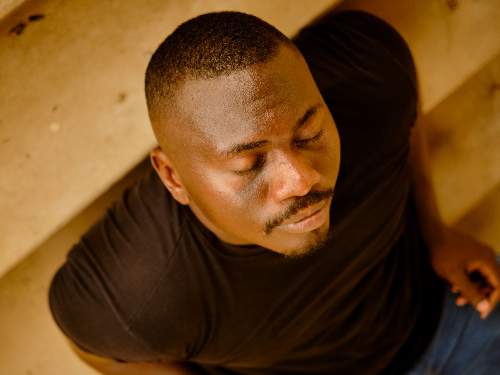 A person pausing with eyes closed before responding