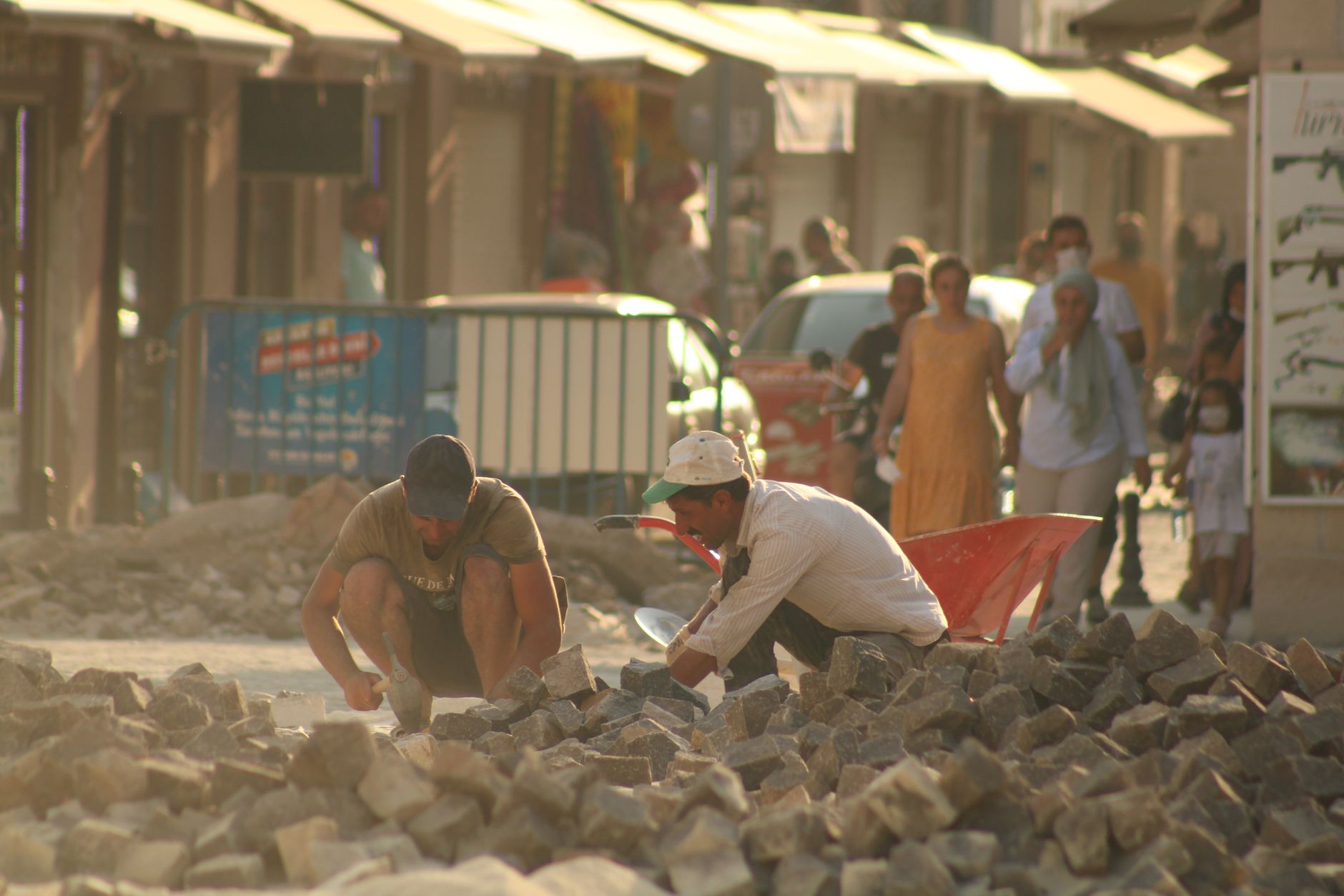 Workers clearing rubble from a damaged building