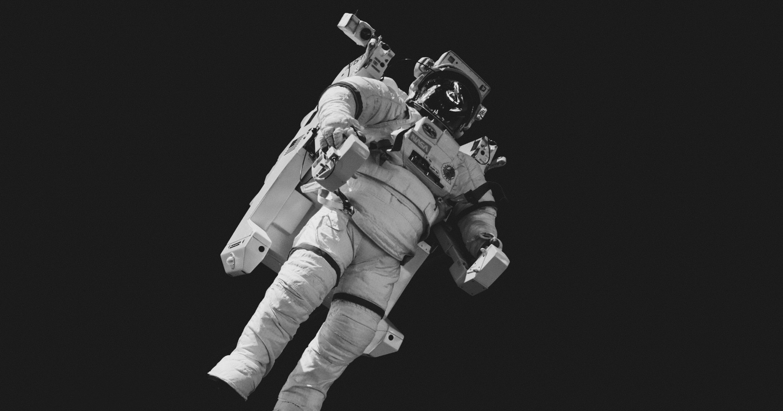 Astronaut floating against a black background